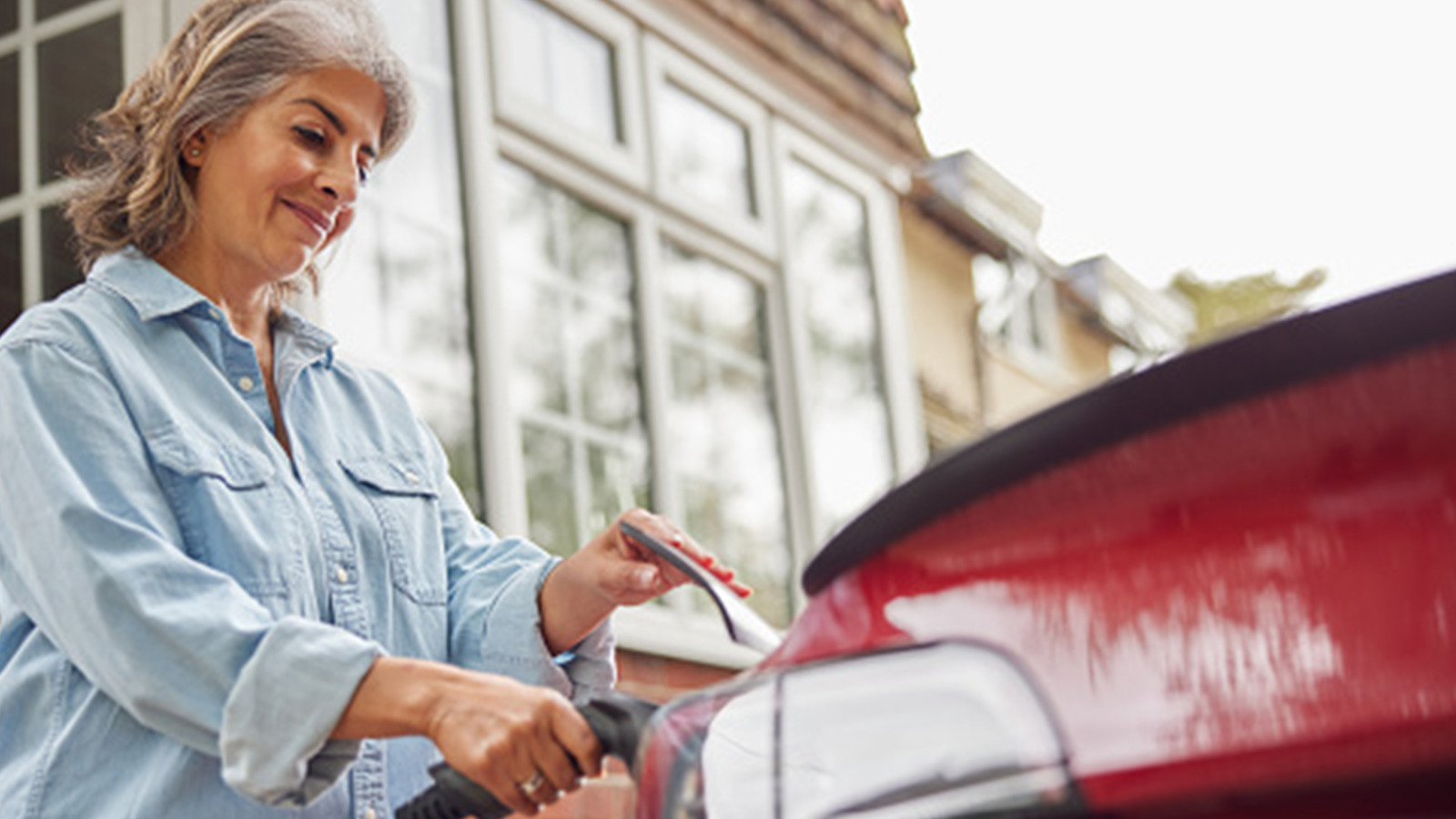 Woman charging vehicle