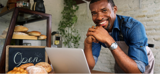 Man on laptop smiling